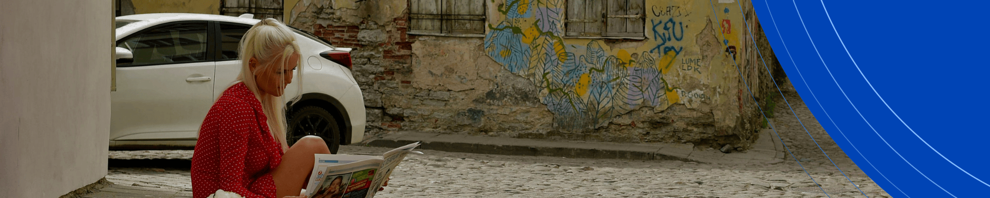 Phots of a woman with blonde hair reading a newspaper
