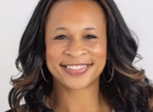 Woman with brown skin long black hair smiling