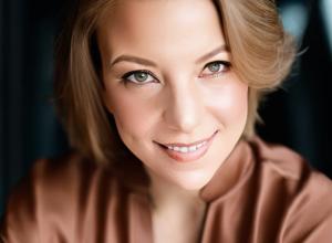 Woman wearing brown blouse smiling